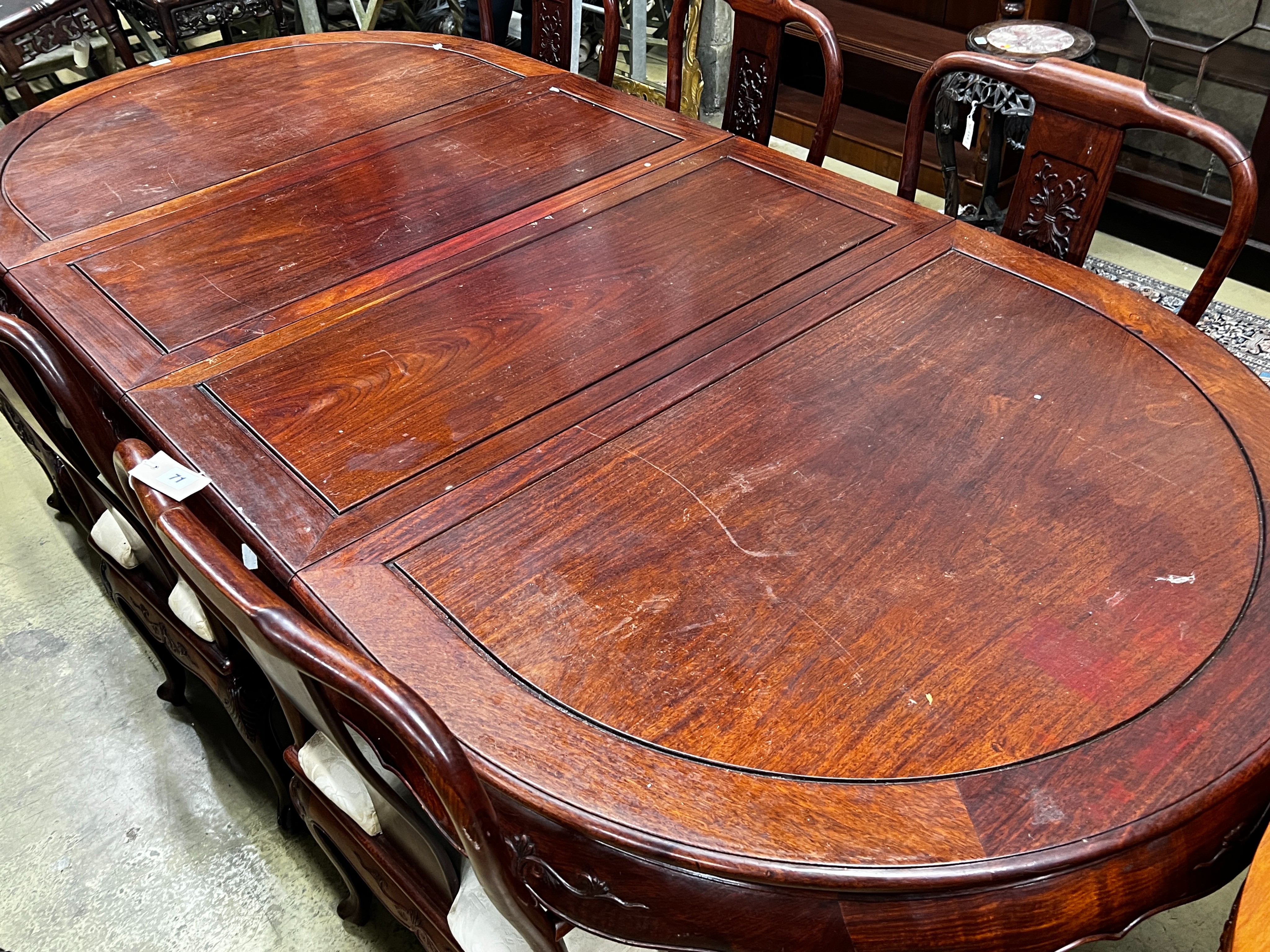 A Chinese hardwood extending dining table, length 244cm extended, two spare leaves, width 110cm, height 78cm and six chairs (2 with arms)